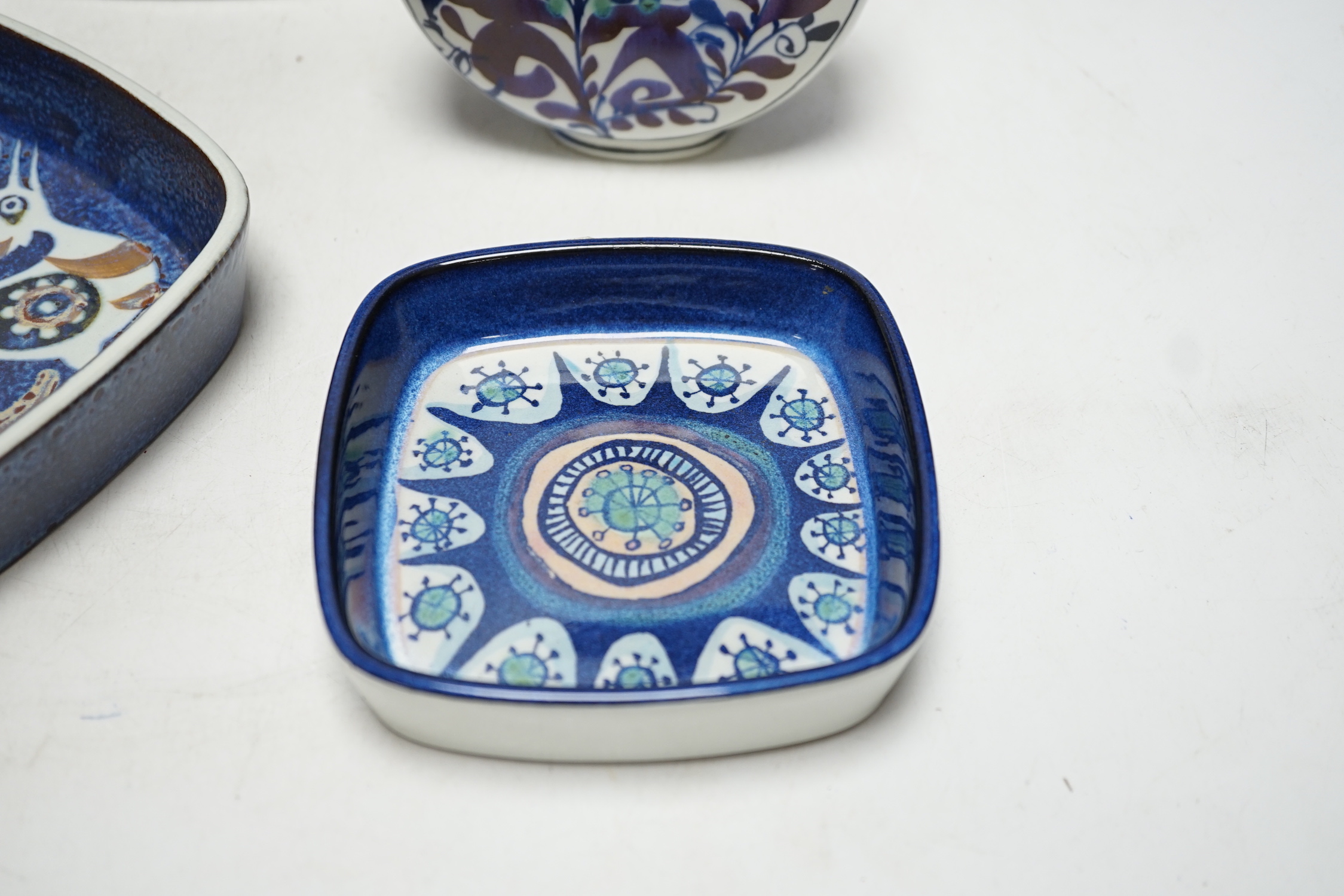 A Royal Copenhagen rectangular section fajance vase and a smaller similar bird decorated vase a circular floral vase and two varying sized square dishes, tallest vase 19cm high